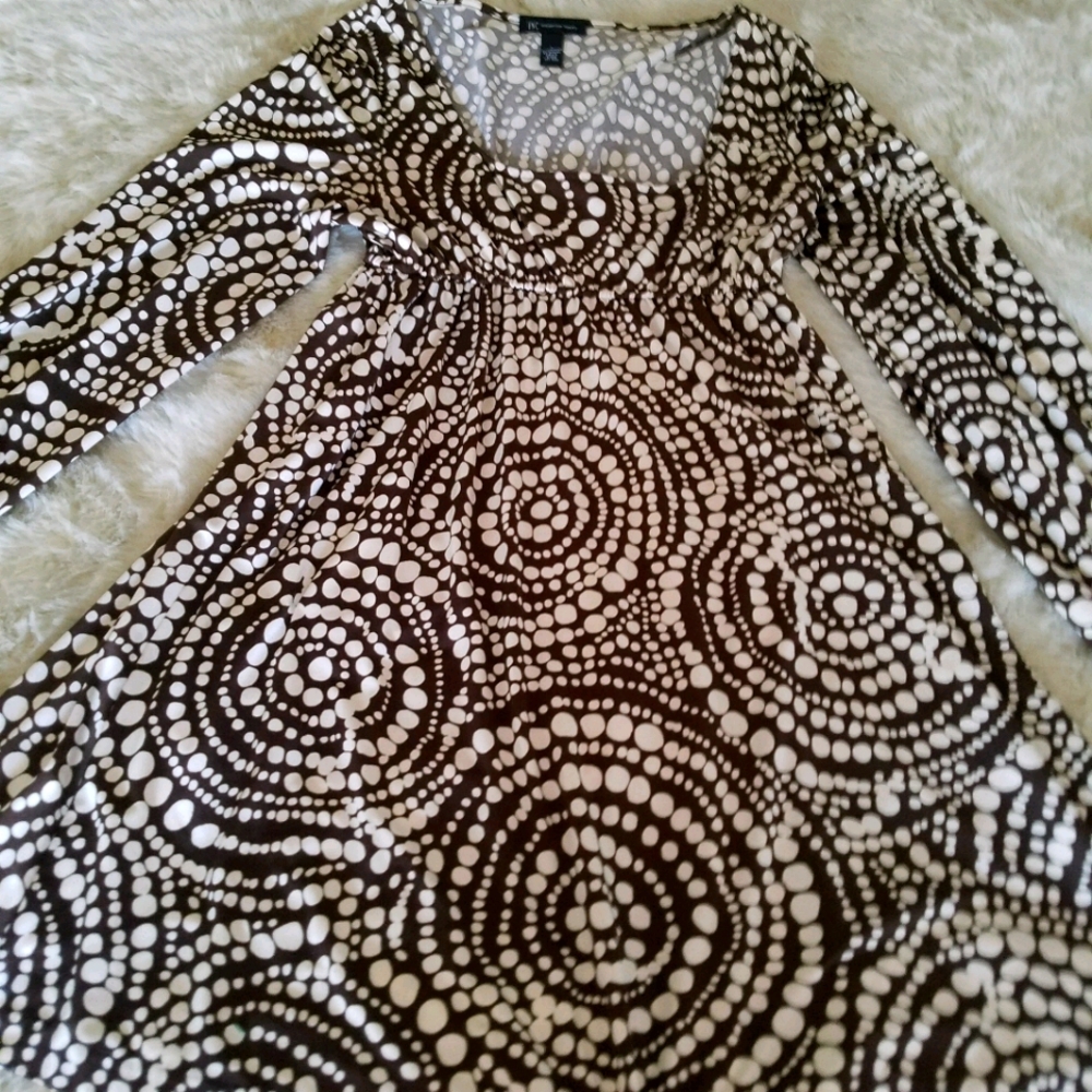 Cream dress with white patterned polka dots.
